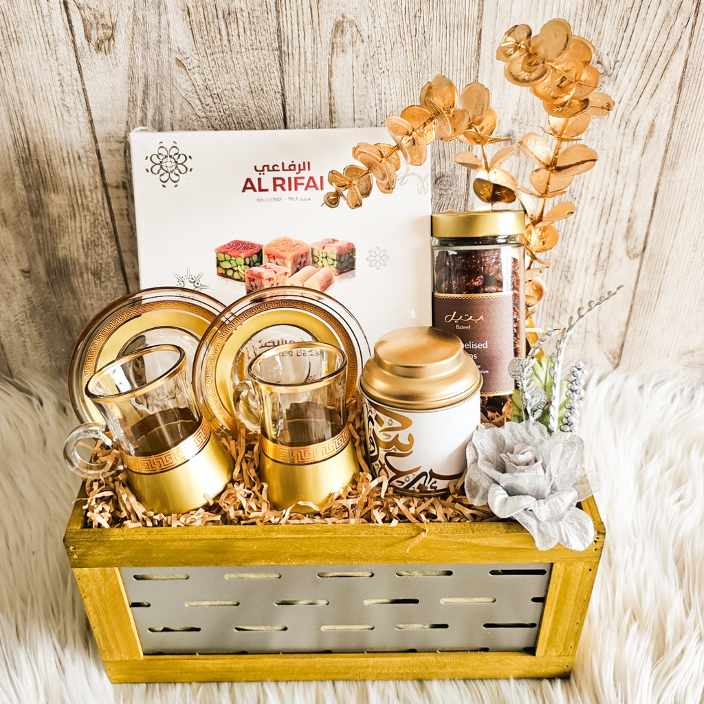 Arabian Nights Eid Gift Basket featuring Bateel caramelized pecans, Kahwa coffee, Turkish cup and saucer, and Al Rifai baklava.