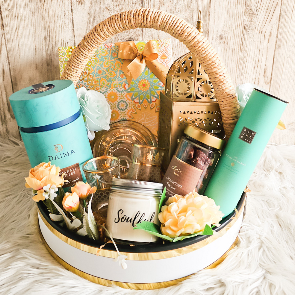 Elegant Ramadan gift basket adorned with assorted dates, fragrance sticks, and decorative items.