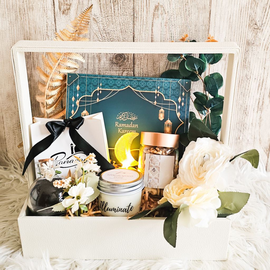 Ramadan Treats gift basket featuring Ramadan themed chocolates, mixed nuts, scented candle, Karak chai, Bateel dates, and a decorative moon-shaped LED light.