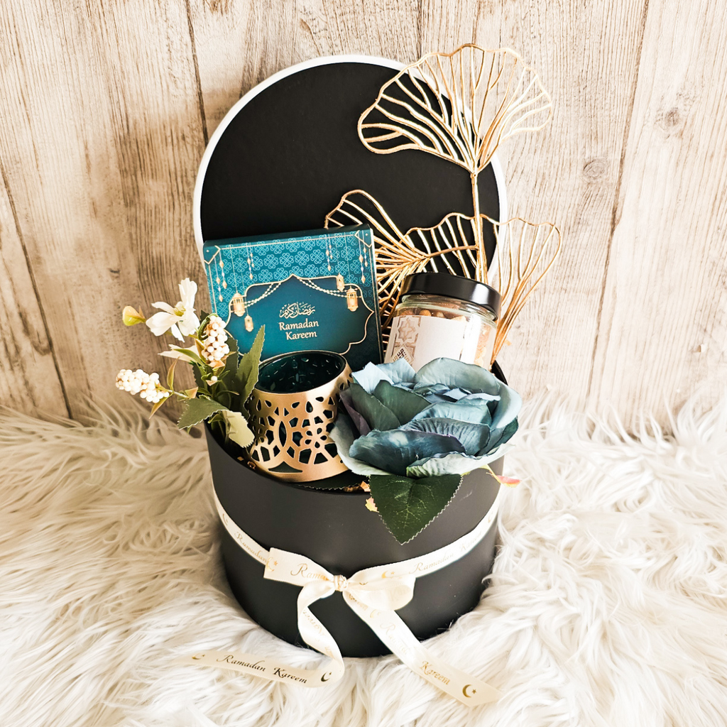 Elegant small gift basket beautifully arranged for Ramadan, showcasing chocolates, dates, and decorative items.